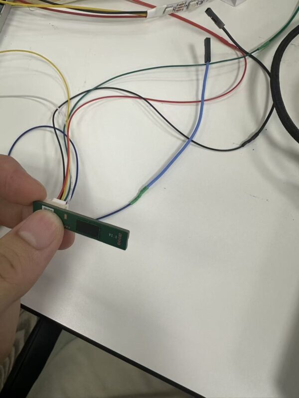 60 GHz AiP radar board with its 6-wire lead ending in female Dupont plugs, ready for 2.54 mm headers